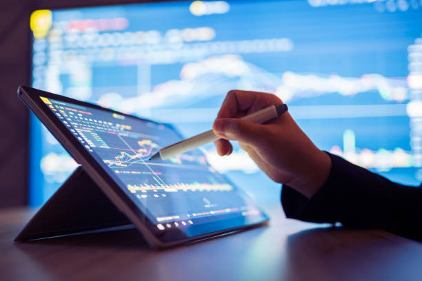 woman looking stock market data on smart phone